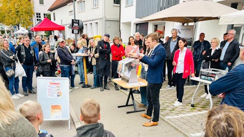 Bürgermeister Treiber bei der Verlosung der Preise am Flohmarktstand der BürgerStiftung