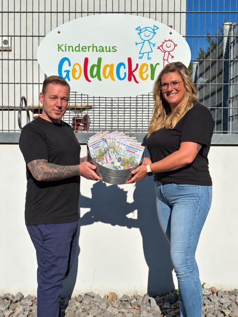 Die Übergabe der Bücher durch Philipp Schütze von Grün&Popp an Julia Schmidt vom Kinderhaus Goldacker